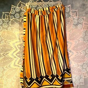 African pink and black striped dress with designs with yellow and red triangles